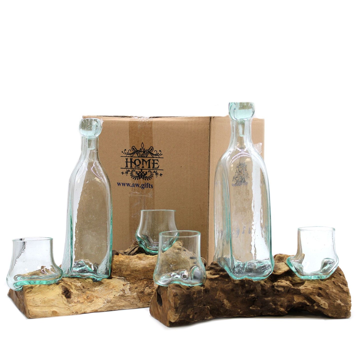 Set of glass bottles and glasses on a wooden stand with a cardboard box in the background.