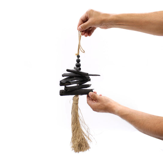 Hanging Driftwood Tassel held up by two hands