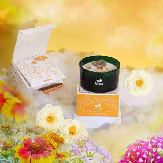 Hop Hare Crystal Magic Flower Candle - The Lion with packaging and flowers on a bright background