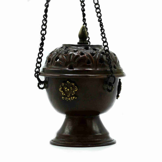Decorative bronze incense burner with intricate designs on a white background