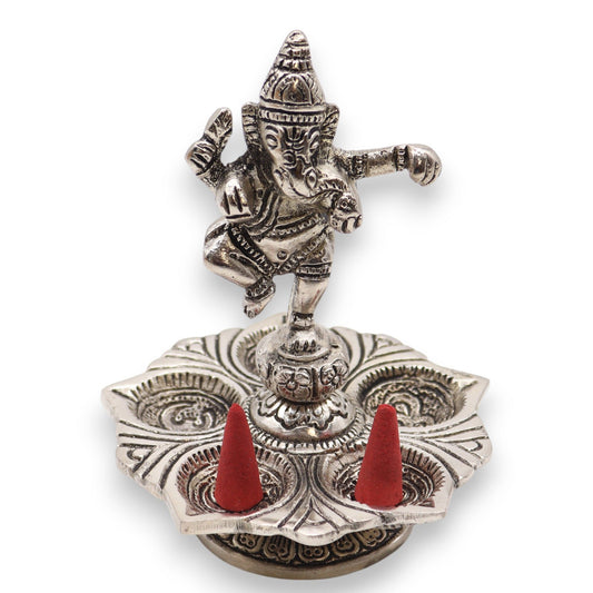 Dancing Ganesha Incense Holder with two red incense cones on a white background