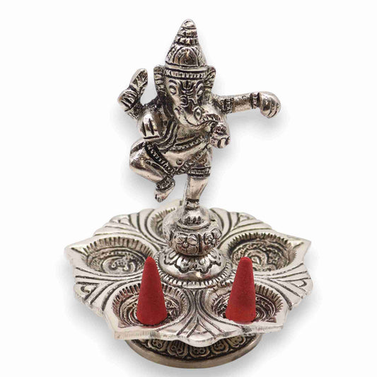 Dancing Ganesha Incense Holder with two red incense cones on a white background