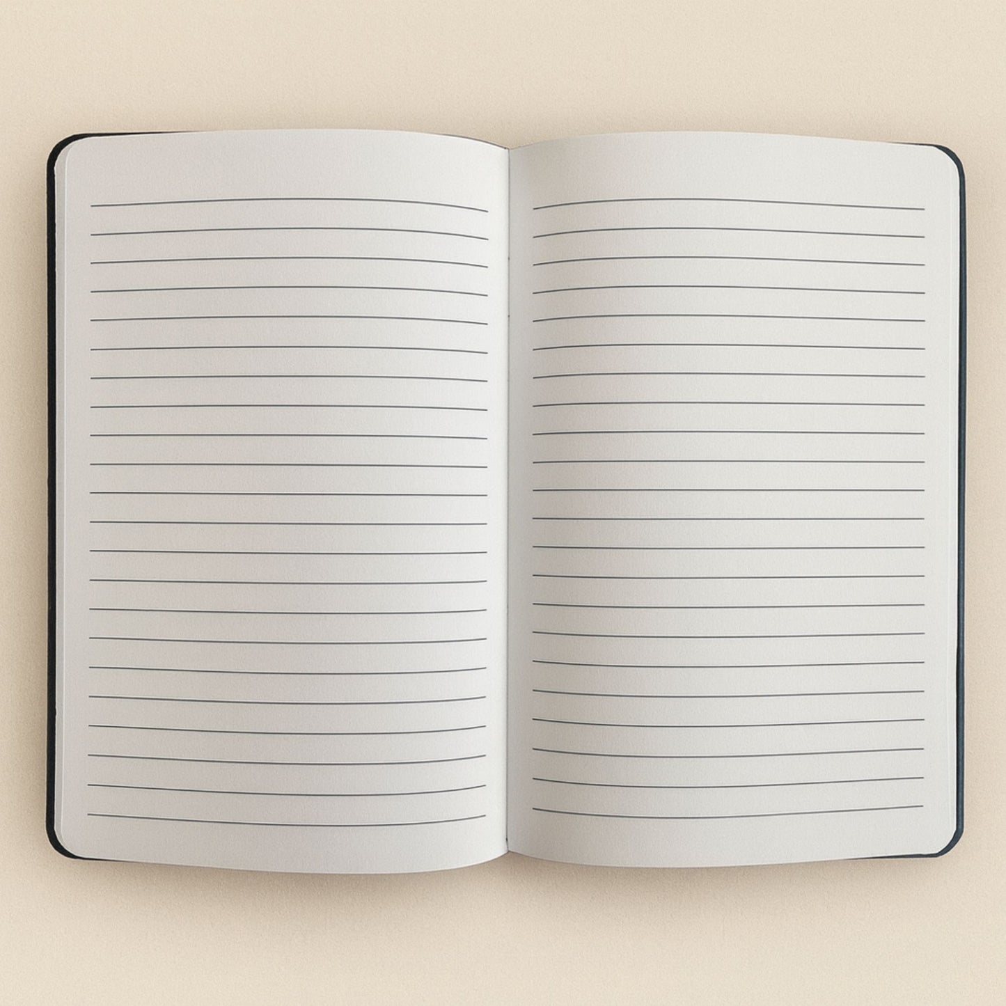 Open notebook with lined pages on a beige background