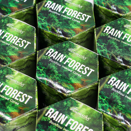 Multiple boxes of Aromatika Rain Forest Backflow Incense Cones stacked together.