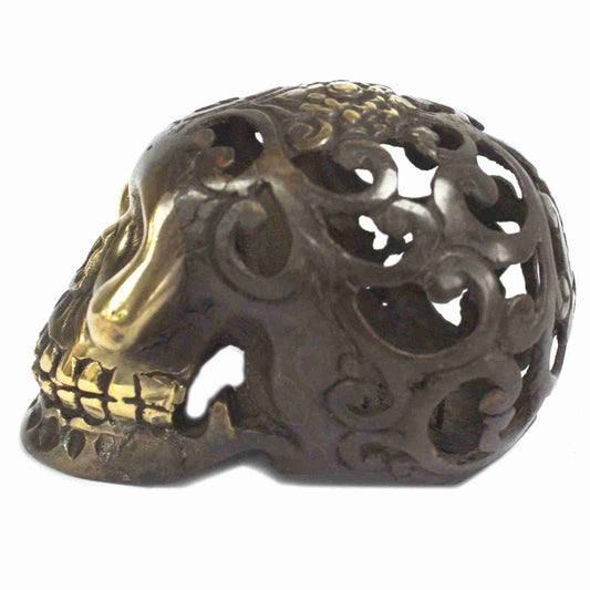 Large Vintage Brass Skull Figurine on a white background, side view.
