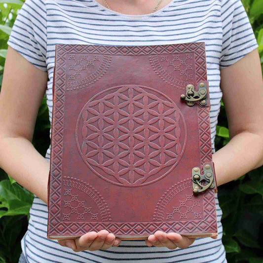 Huge Flower of Life Leather Book beig hed by a person to show size