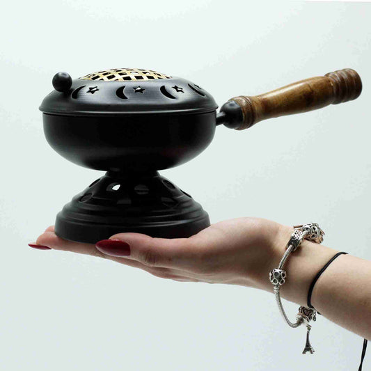 Large Iron Censer on Stand Incense Burner - Gold detail held by a hand on a white background