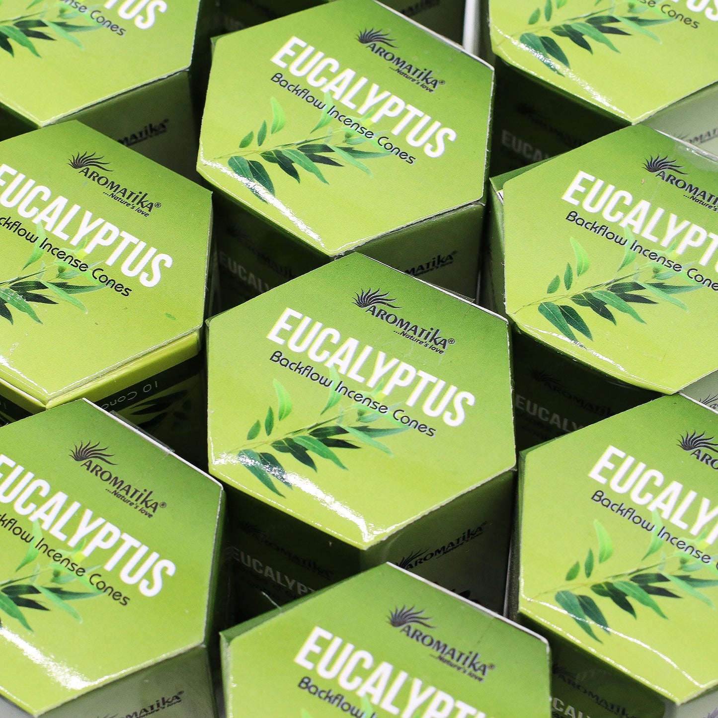 Multiple boxes of Aromatika Eucalyptus incense cones on a black background