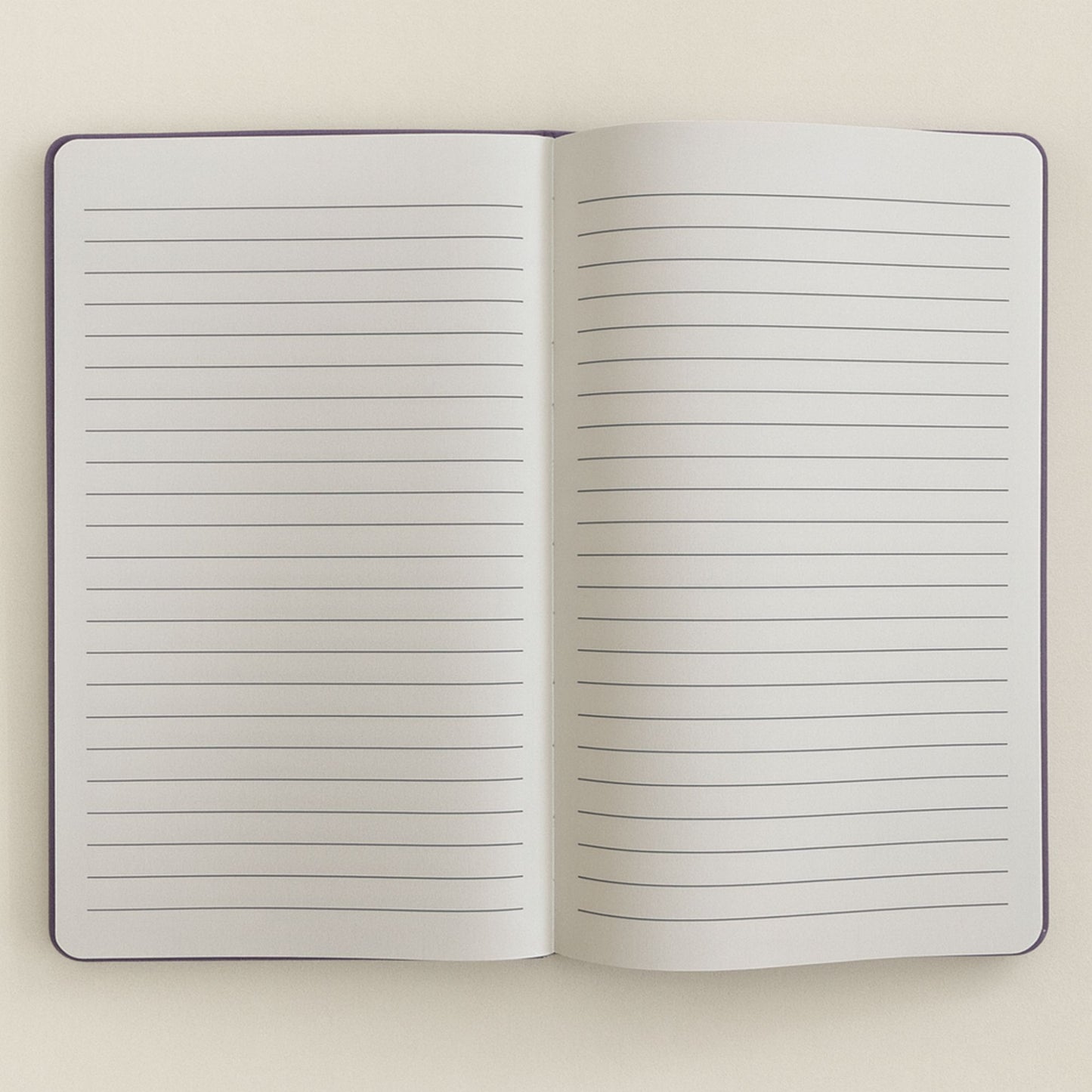 Open notebook with lined pages on a light beige background