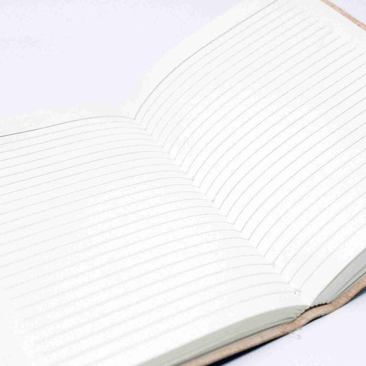 Close-up of a notebook with lined pages on a white background