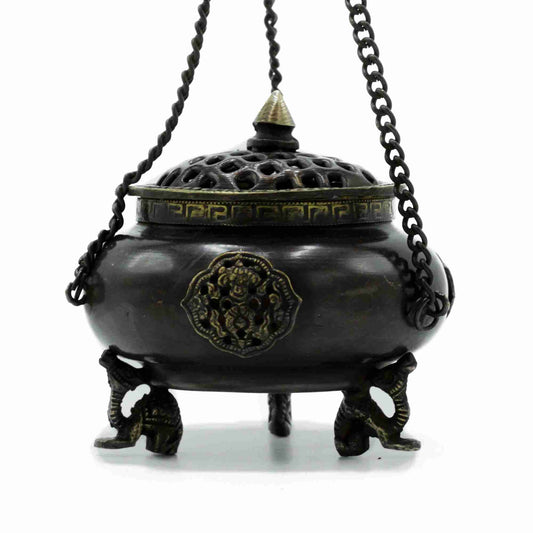 Bronze incense burner with decorative elements on a white background