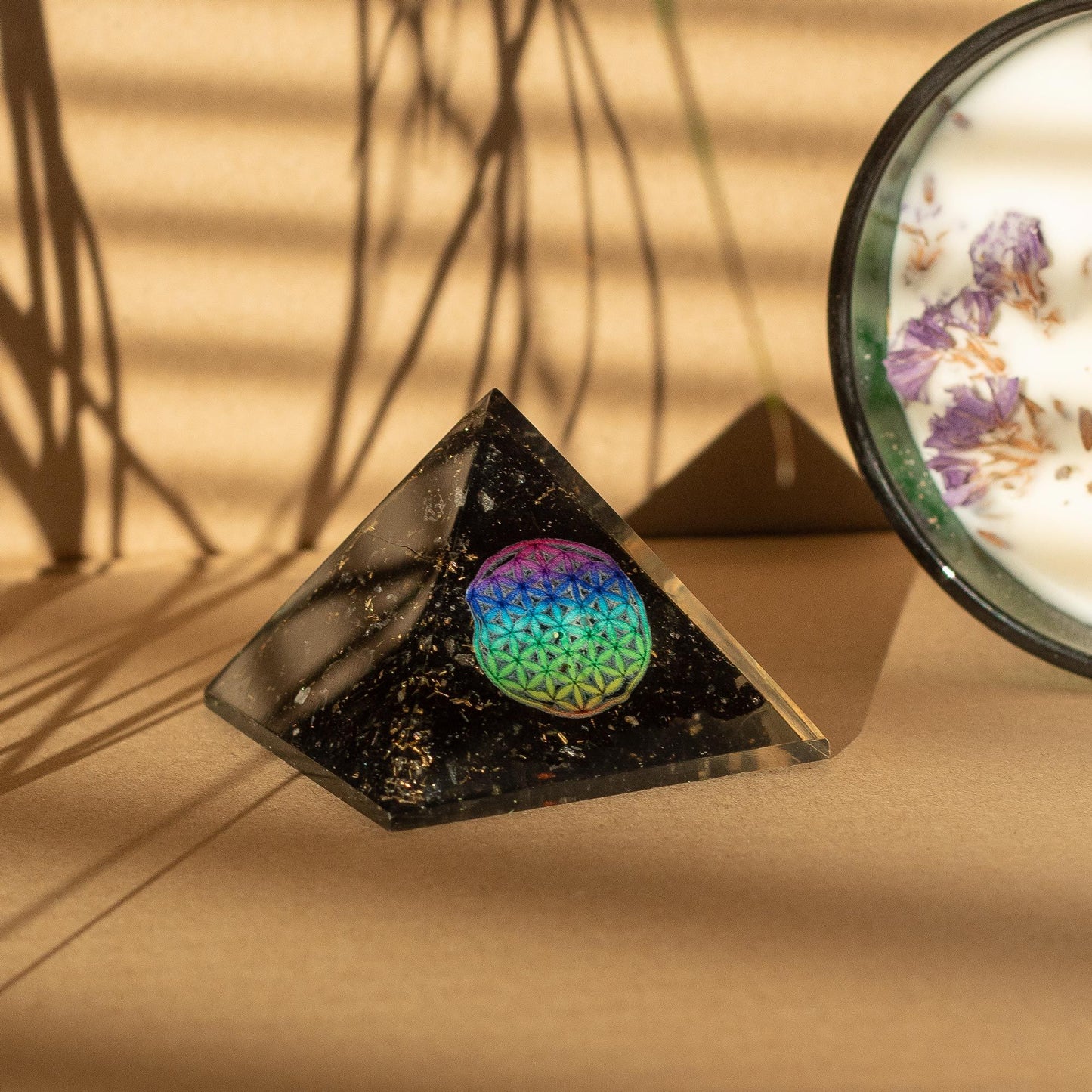 Small Orgonite Pyramids 5.5x4.5cm - Flower of Life - Black Tourmaline Chips with a beige background