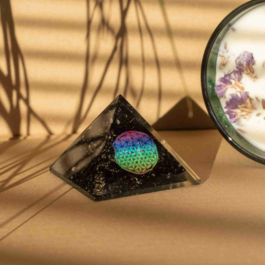 Small Orgonite Pyramids 5.5x4.5cm - Flower of Life - Black Tourmaline Chips with a beige background