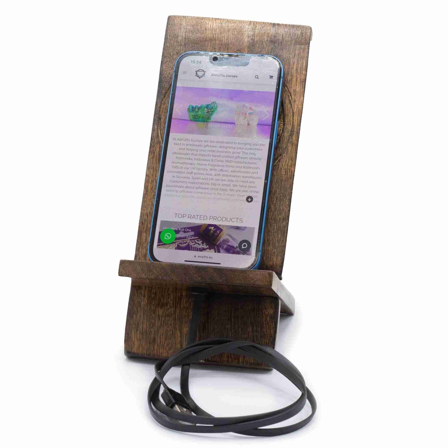 Wooden phone stand holding a smartphone with a white background