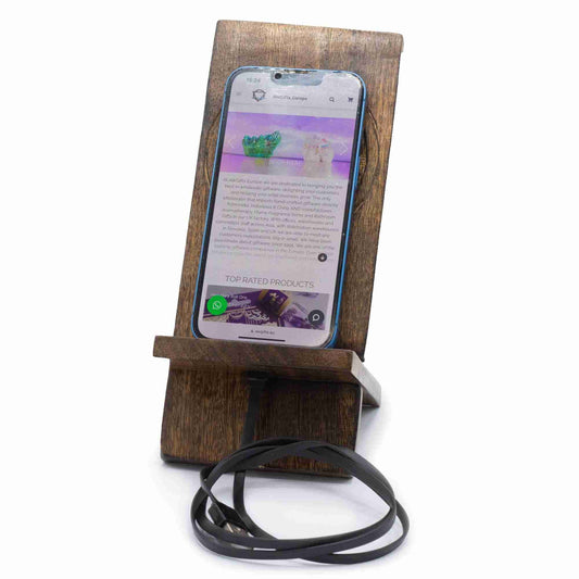 Wooden phone stand holding a smartphone with a white background