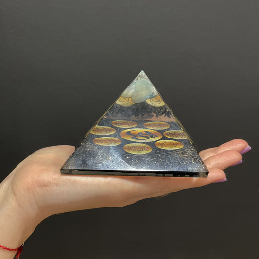 Orgonite Pyramid - Midnight Om Chakra held in a hand