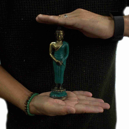 Person holding a Medium Standing Brass Buddha Figurine between their palms