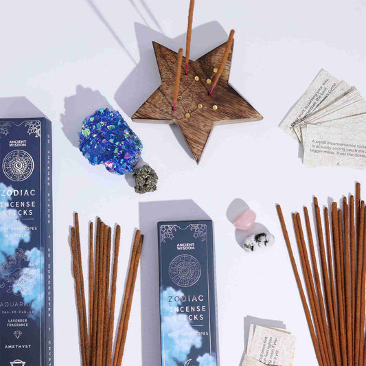 Zodiac incense sticks with packaging and decorative items on a white background