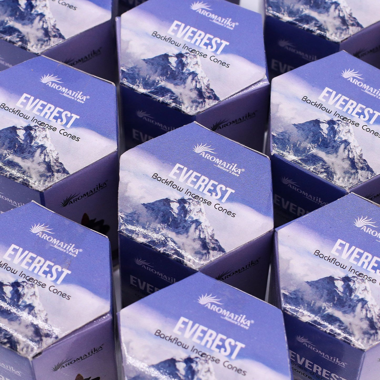 Multiple boxes of Aromatika Everest Backflow Incense Cones with mountain imagery.