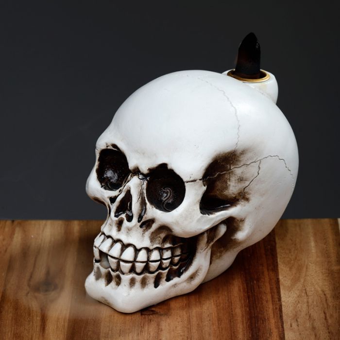 Skull Backflow Incense Burner - Gothic Smoke Waterfall on wooden table.