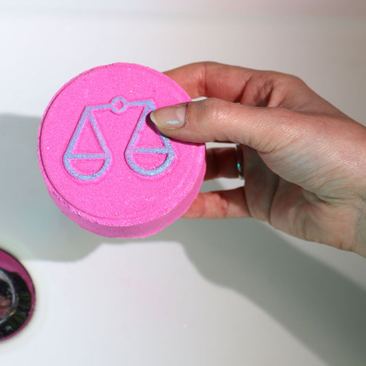 Set of Zodiac Bath Fizzers with Horoscope - Libra held in persons hand