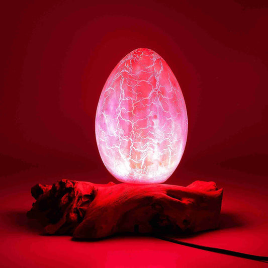 Glowing pink egg-like object on a red background