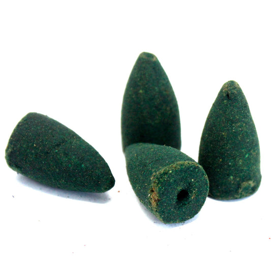 Four green conical incense cones on a white background