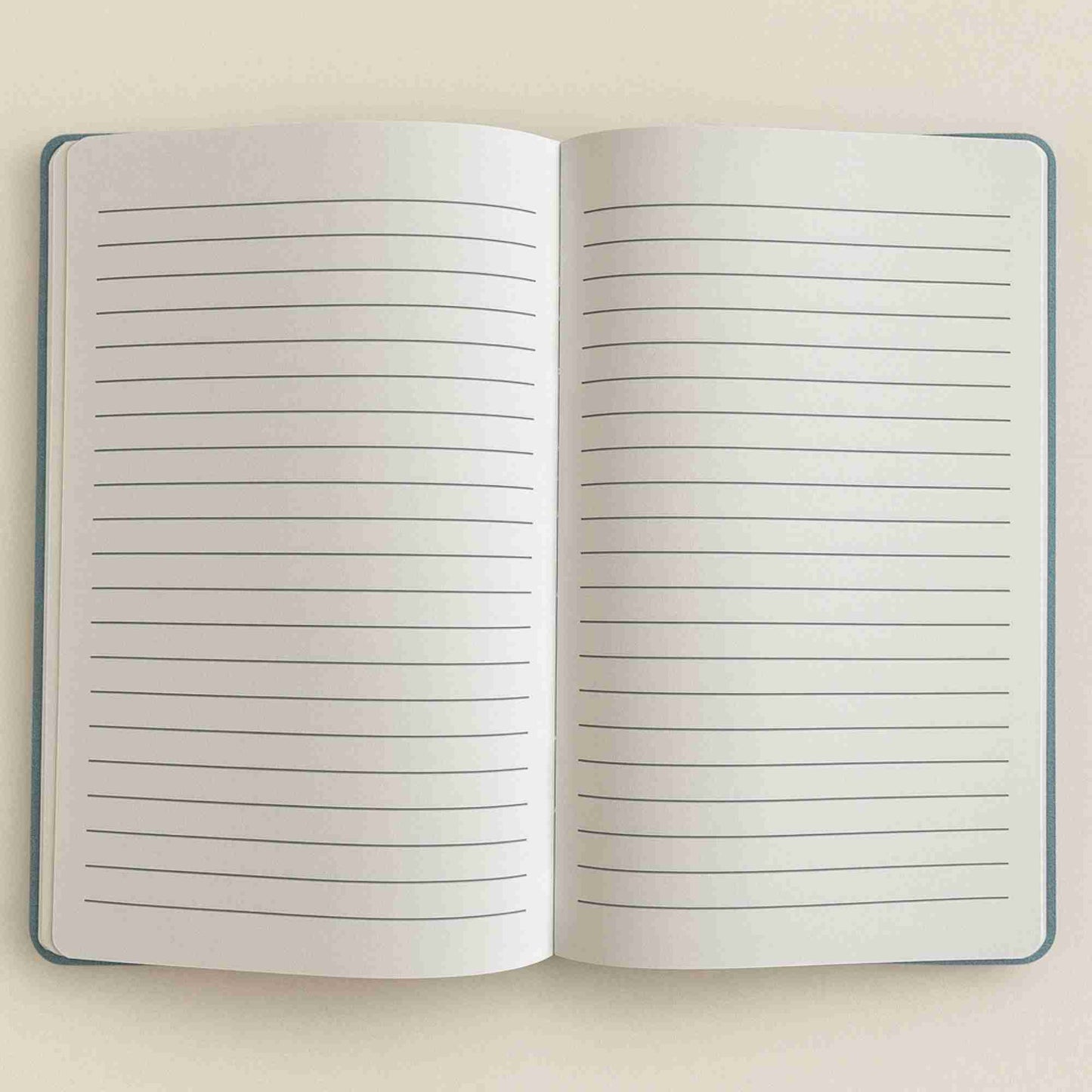 Open notebook with lined pages on a beige background