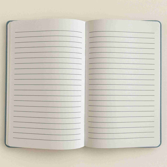 Open notebook with lined pages on a beige background
