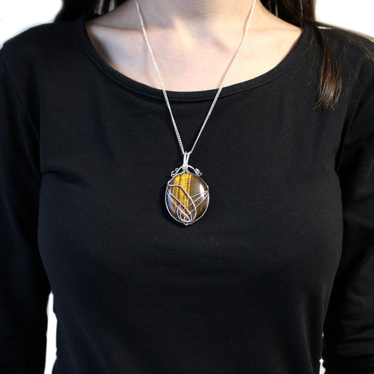 Person wearing a black shirt with Swirl Wrapped Gemstone Necklace - Tiger Eye