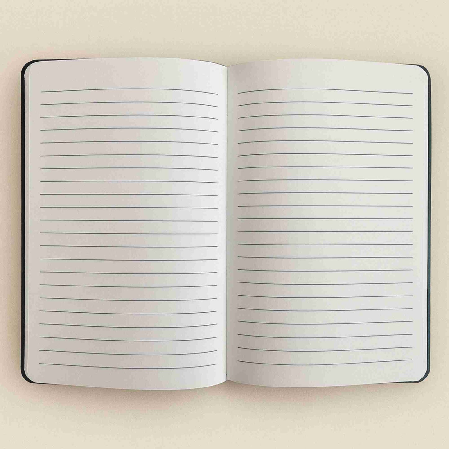 Open notebook with lined pages on a beige background