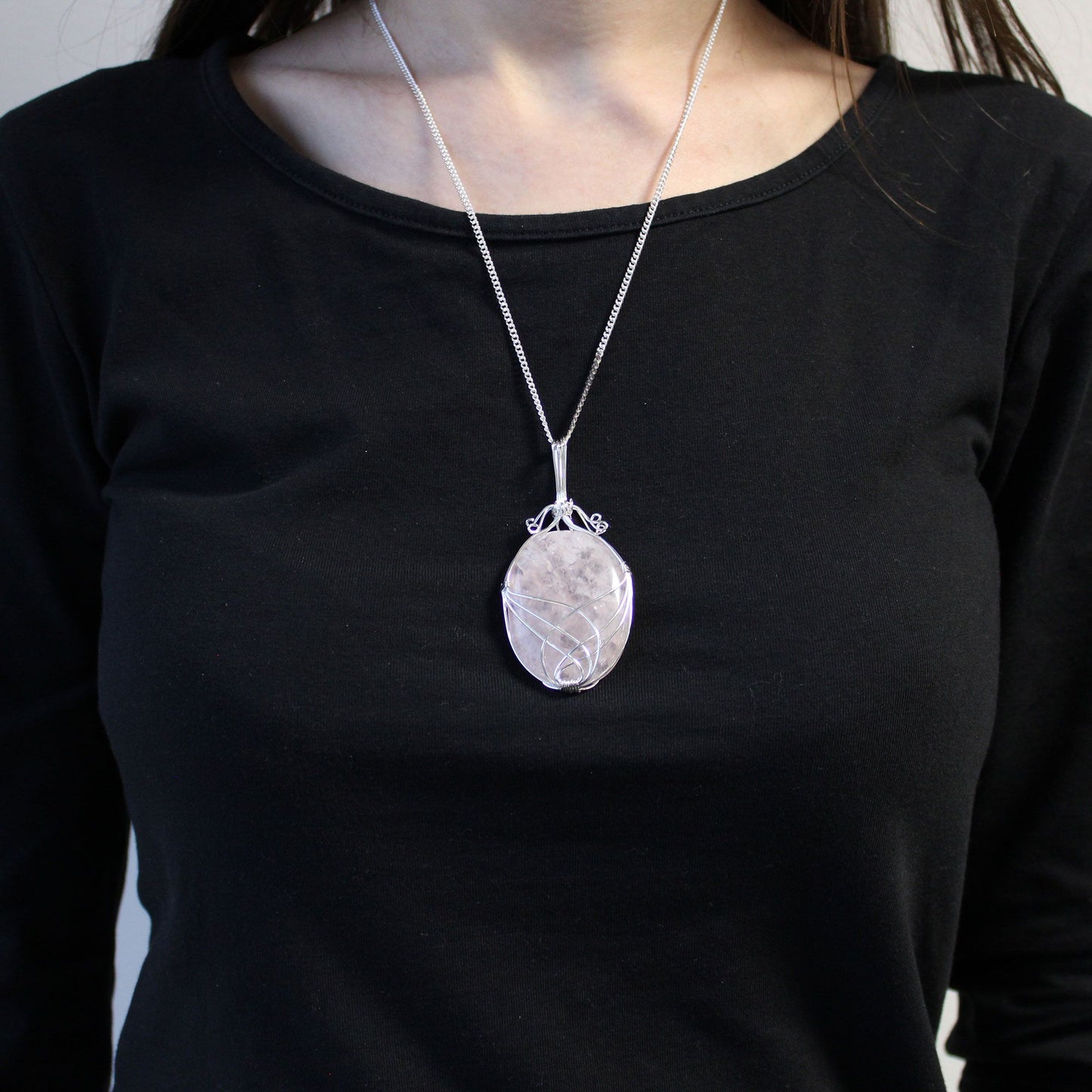 Person wearing a black shirt with Swirl Wrapped Gemstone Necklace - Opalite