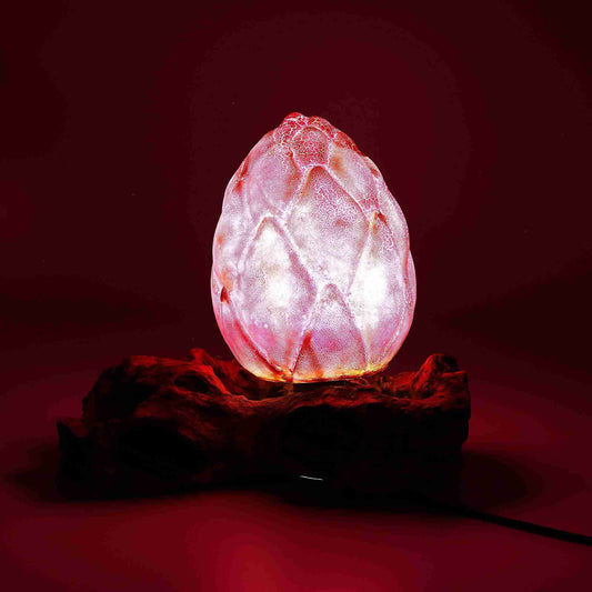 Pink crystal egg-shaped lamp on a dark red background
