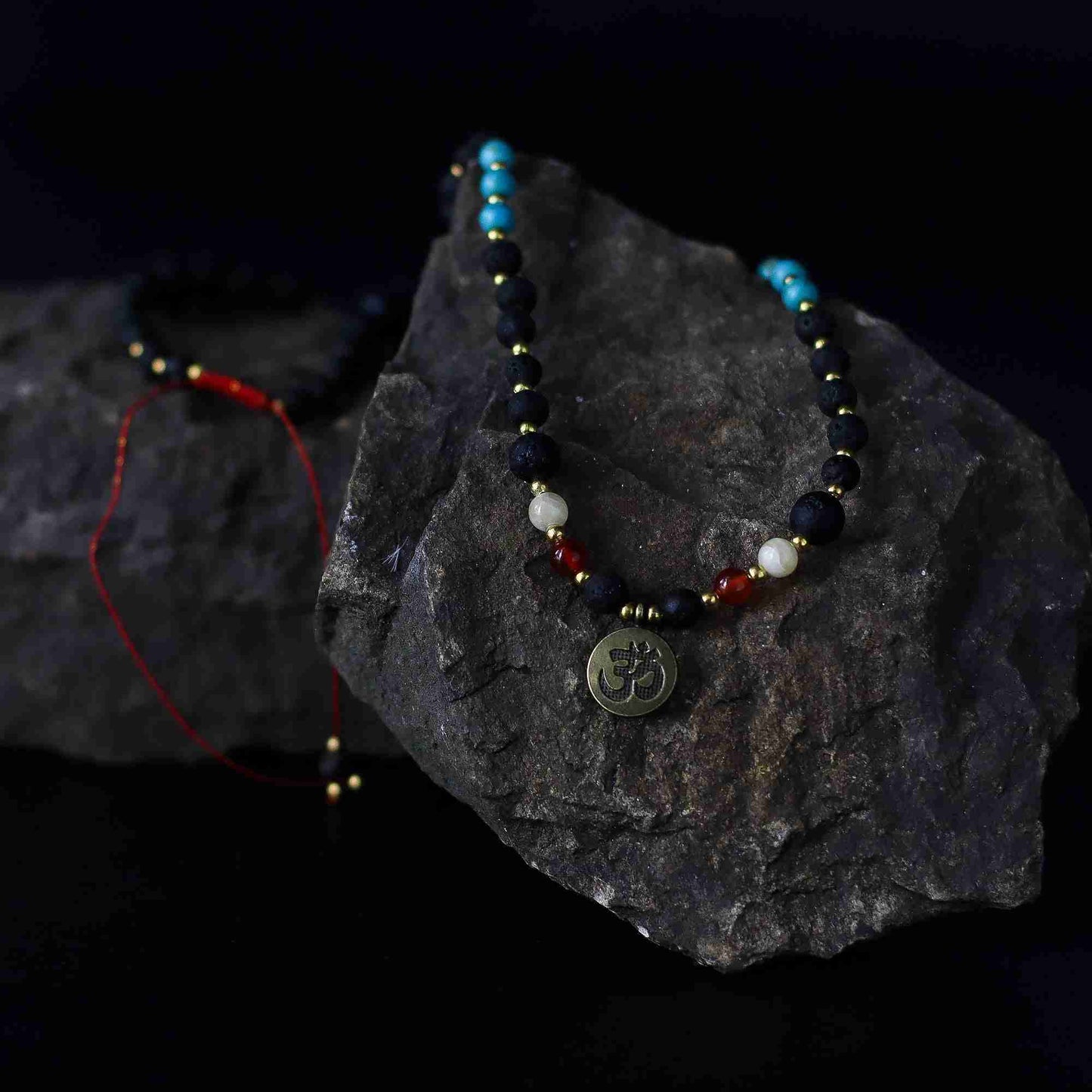 Essence of the Volcano Necklace with a pendant on a dark stone surface