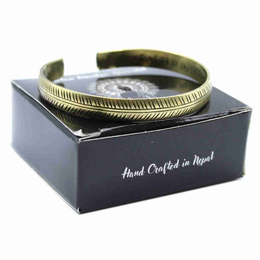 Brass Tibetan Bracelet on a black box with 'Hand Crafted in Nepal' text