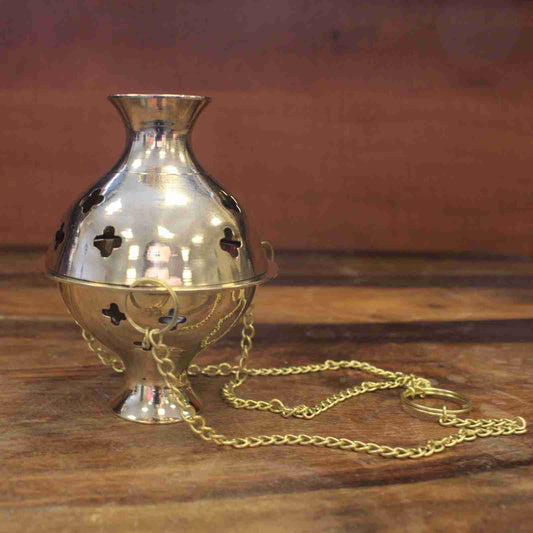 Hanging Brass Incense Burner on a wooden surface