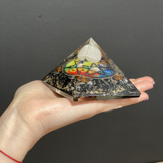 Orgonite Pyramid - Midnight Pentagon held in a persons hand