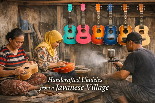Javanese artisans sanding and spray-painting handmade ukuleles in a traditional village workshop, with six colourful finished ukuleles hanging above