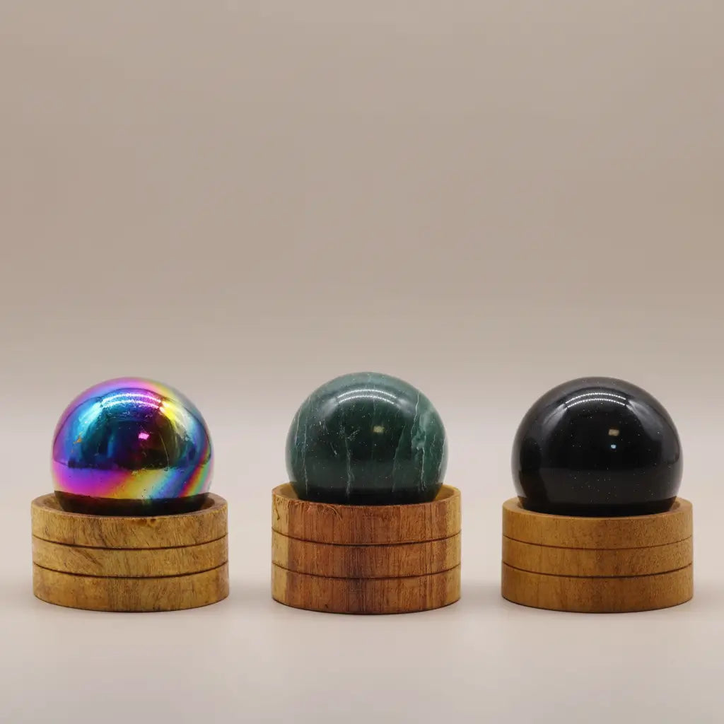 Hand-carved gemstone crystal spheres with wooden stands - Amethyst Aura, Indian Jade, and Ocean Agate