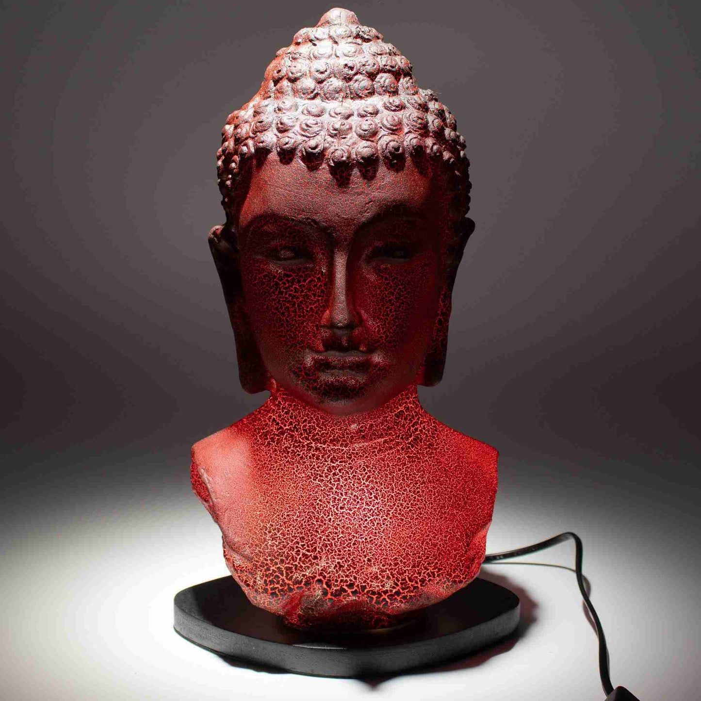 Buddha Bust Lamp Molten Lava on a dark background