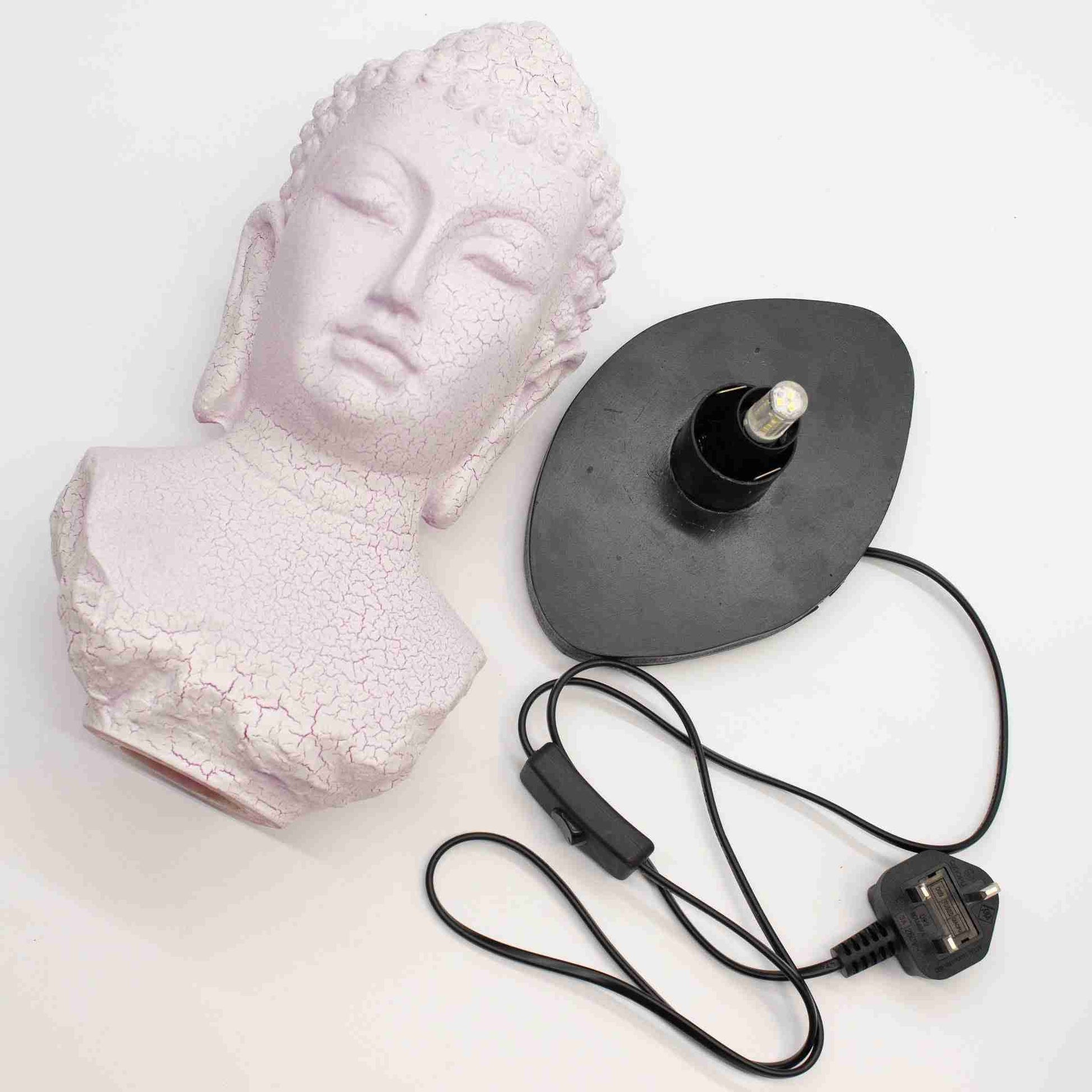 Cherry Crackle Buddha Bust Lamp next to a black lamp base with cord on a white background.