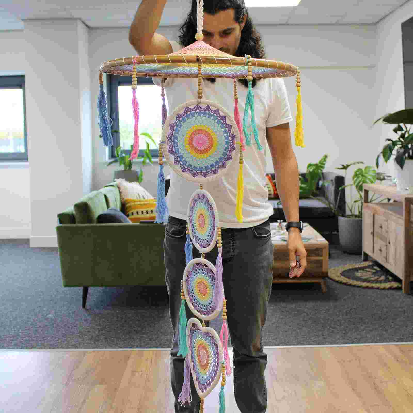 Person holding an Extra Large Drama Dreamcatcher Pastel Rainbow in an office setting