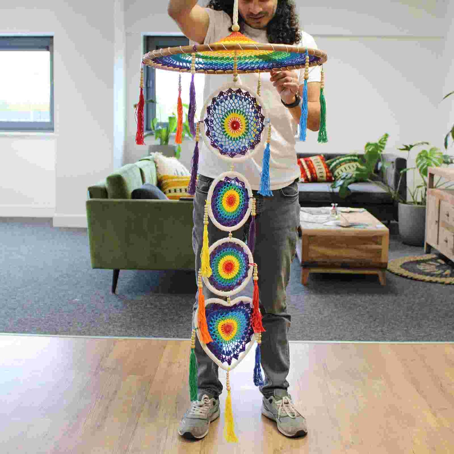 Person holding an Extra Large Drama Dreamcatcher Vivid Rainbow in an indoor setting