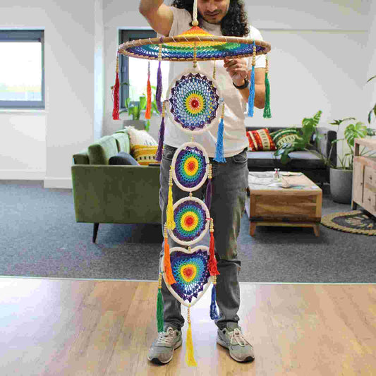 Person holding an Extra Large Drama Dreamcatcher Vivid Rainbow in an indoor setting