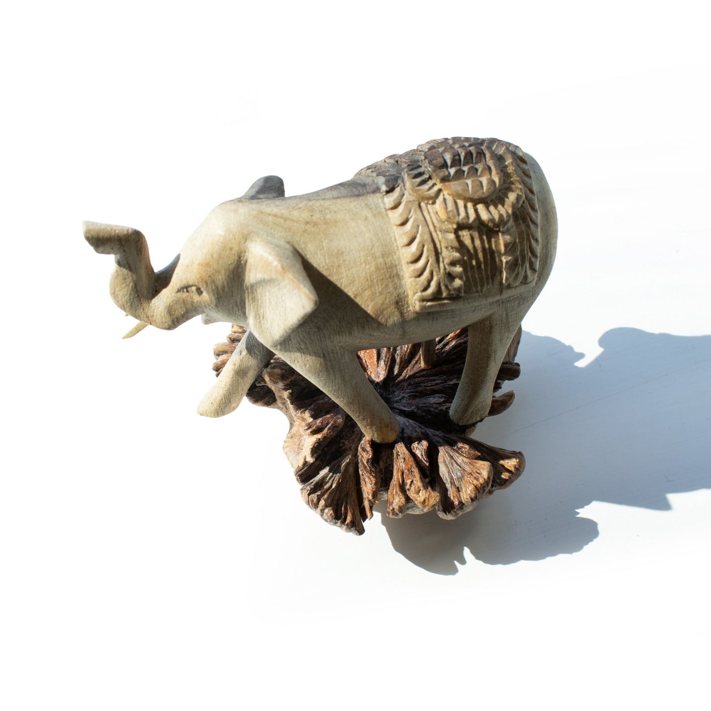 Handmade Parasite Wood Art Carving Elephant Walking on a white background, top view.