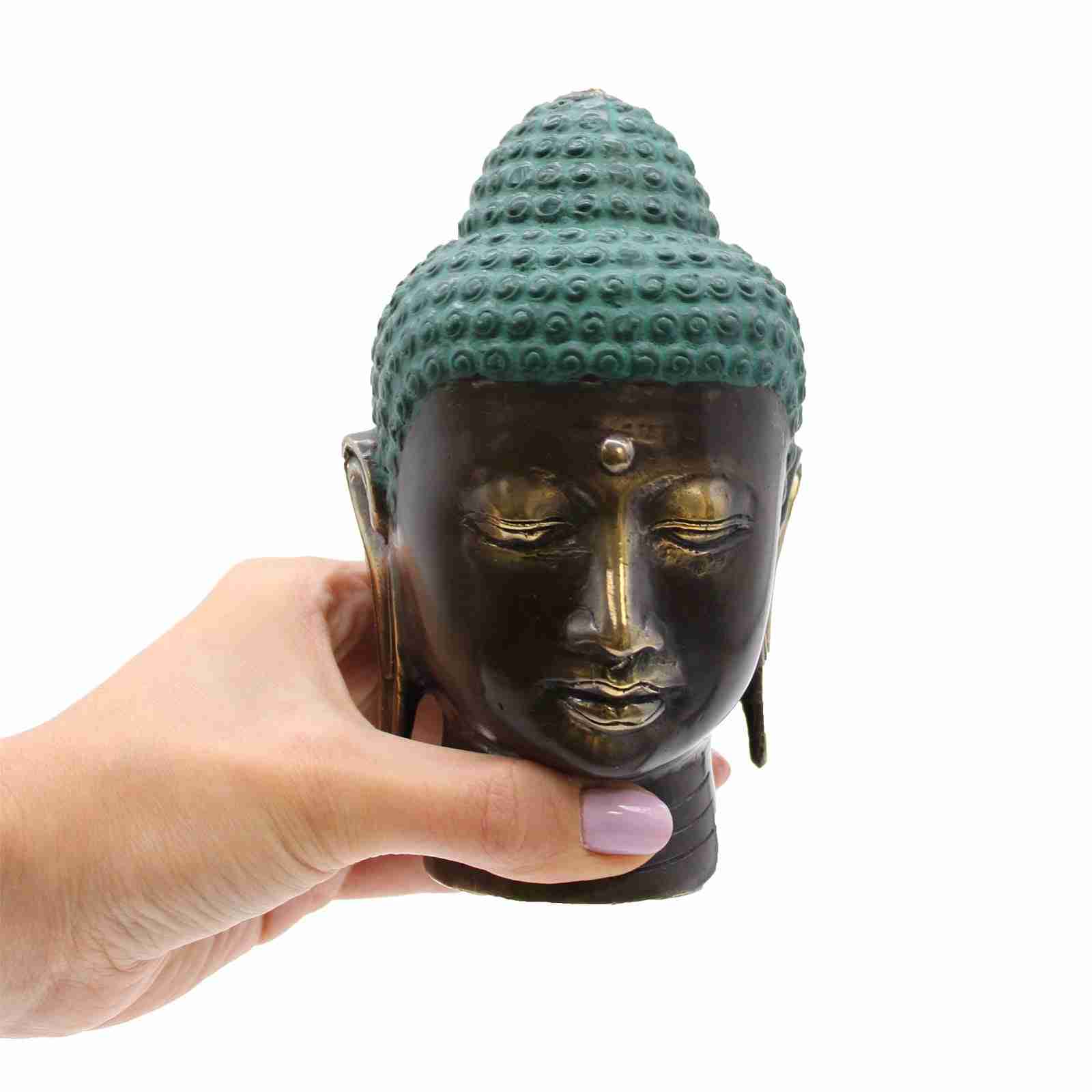 Large Antique Brass Buddha Head Figurine held by a hand with a white background.
