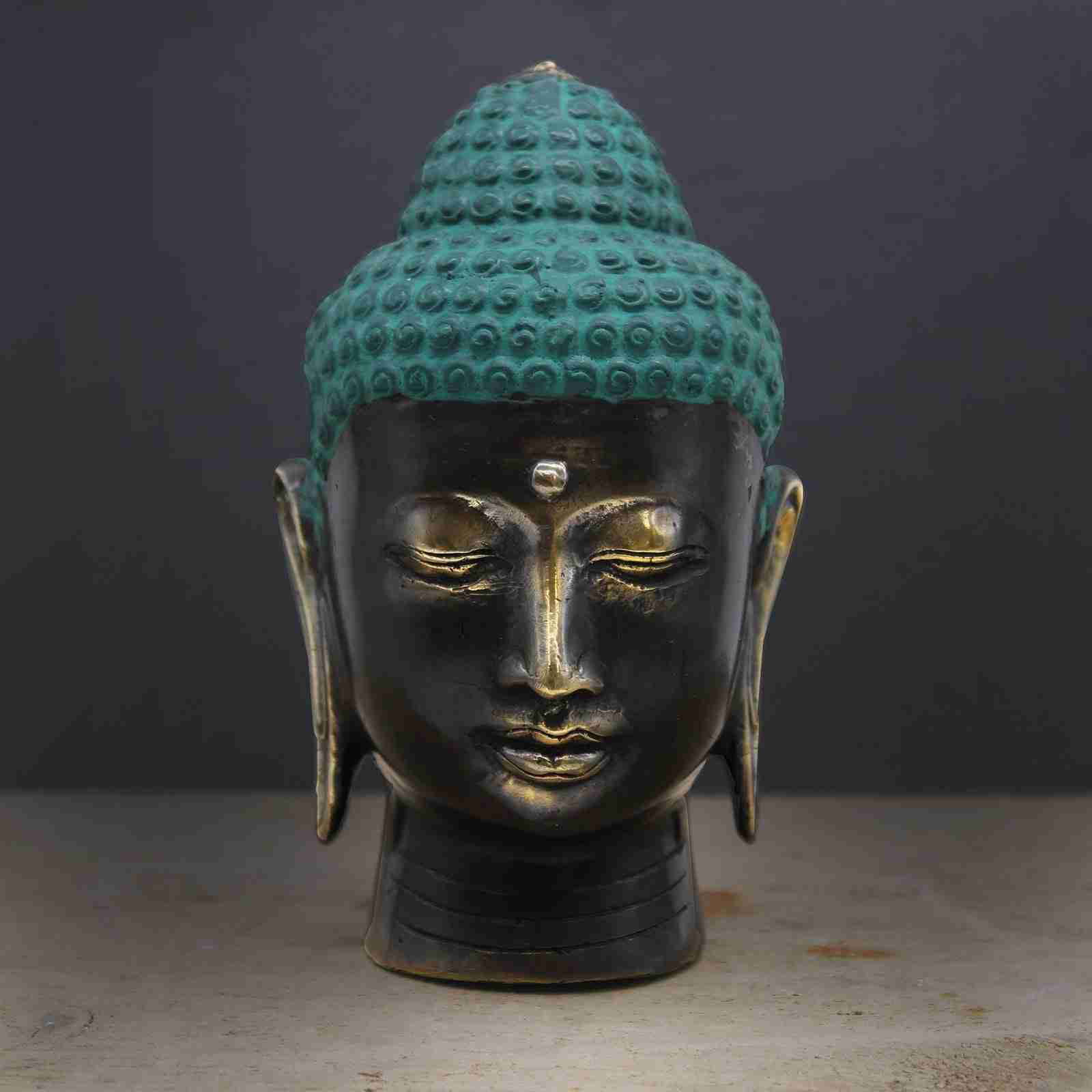 Large Antique Brass Buddha Head Figurine on a dark background