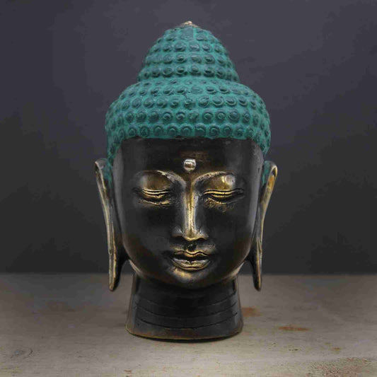 Large Antique Brass Buddha Head Figurine on a dark background
