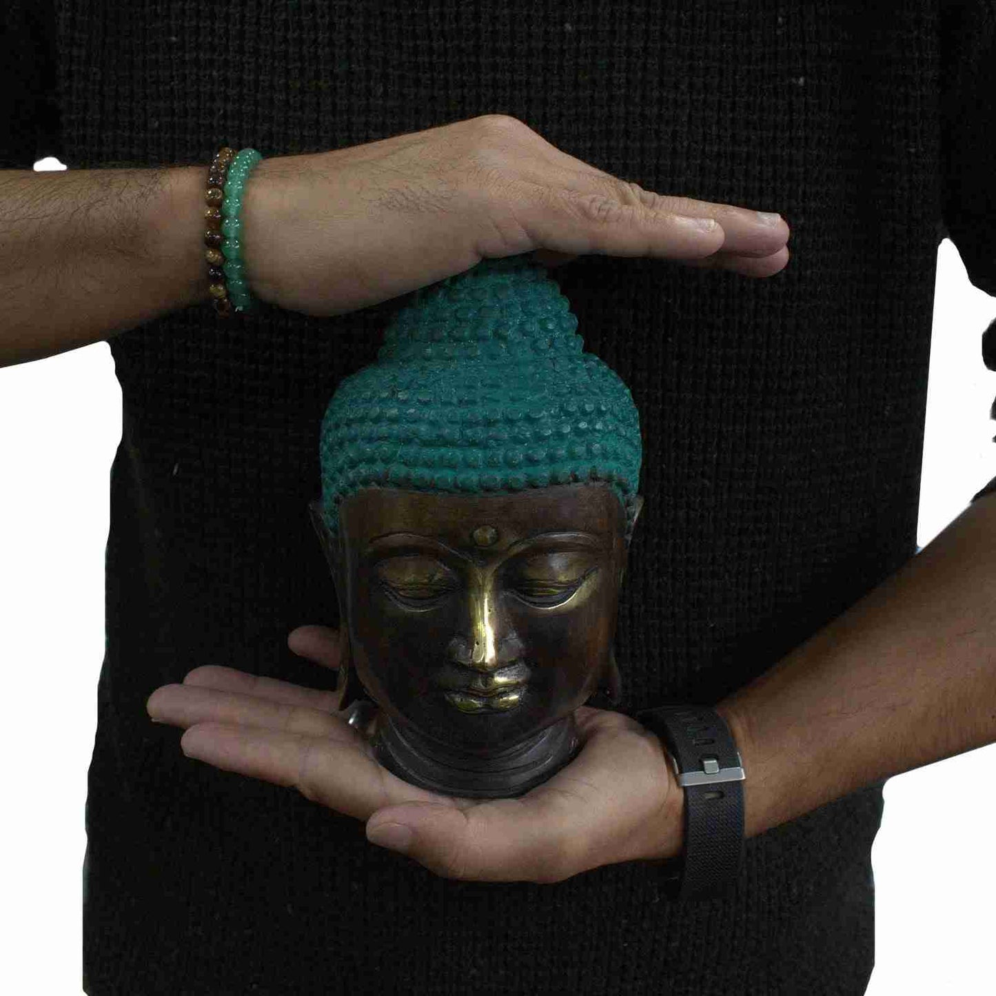 Person holding a Large Brass Buddha Head Figurine Classic against a black background