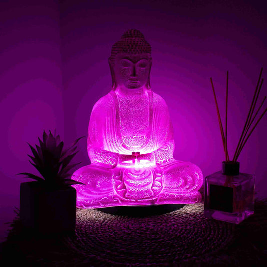Meditation Buddha Lamp Cherry Crackle with light on in a dark room.
